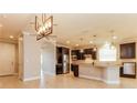 Open concept kitchen with island and dark wood cabinets at 368 Toldedo Rd, Davenport, FL 33837