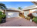 Spacious two-car garage with brick paved driveway and mature landscaping at 1694 Town Park Dr, Port Orange, FL 32129