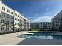 Resort-style pool with apartment buildings in background at 1210 Southstation Pi # 202, Orlando, FL 32809