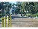 Community gate with wrought iron, two decorative wreaths, and yellow bollards at 4340 S Kirkman Rd # 905, Orlando, FL 32811