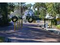 Gated entrance to the Sunset Lake community with black iron fence and decorative wreaths at 4340 S Kirkman Rd # 905, Orlando, FL 32811