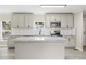 Modern kitchen with white cabinets, granite counters, and stainless appliances at 3046 Crystal Hills Dr, Lakeland, FL 33801