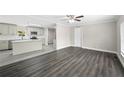 Open living room and kitchen with grey vinyl plank flooring at 3046 Crystal Hills Dr, Lakeland, FL 33801