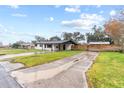 Front view of a remodeled home with a long driveway at 832 Princeton St, Lakeland, FL 33809