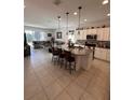 Open kitchen with granite island, stainless steel appliances, and breakfast bar at 478 Disa Dr, Davenport, FL 33837