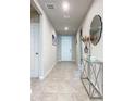 Bright entryway with tile floors and a modern console table at 3052 Cassidy Ln, Haines City, FL 33844