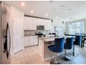 Modern kitchen with white cabinets, granite counters, and stainless steel appliances at 3052 Cassidy Ln, Haines City, FL 33844