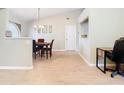 Dining area with a wooden table, chandelier, and hardwood floors at 2226 Baker Ave, Orlando, FL 32833