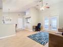 Bright living room with vaulted ceilings, laminate floors, and french doors at 2226 Baker Ave, Orlando, FL 32833