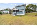 Two-story home showcasing a cozy screened porch and a spacious grassy yard at 5431 9Th Se St, Lakeland, FL 33812