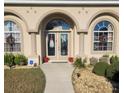 Front entrance with double doors and decorative wreaths at 1910 Nw 85Th Loop, Ocala, FL 34475