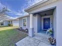 Inviting front porch with a blue door and white columns at 1621 Saddlehorn Dr, Lakeland, FL 33810