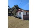 Side view of a single story home with red trim at 2150 Ne 54Th St, Ocala, FL 34479