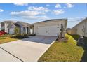 House exterior showcasing a two-car garage and well-maintained lawn at 4832 Cranberry Way, Lakeland, FL 33811