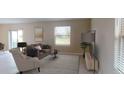 Living room with sofa, armchair, coffee table, and TV stand at 673 Bell Prairie Cir, Lake Wales, FL 33859