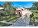 Two-story house next to a lake, with a backyard at 16741 Rising Star Dr, Clermont, FL 34714