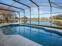 Screened-in pool and spa with lake view at 16741 Rising Star Dr, Clermont, FL 34714