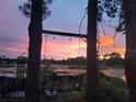 Relaxing sunset view over a serene lake from a hammock at 2449 E Lake Dr, Deland, FL 32724