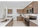 Beautiful kitchen featuring stainless steel appliances, shaker cabinets, and white backsplash at 4471 Sw 84Th Street Rd, Ocala, FL 34476
