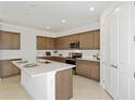 Modern kitchen with shaker cabinets, stainless appliances, quartz countertops, and large island at 4471 Sw 84Th Street Rd, Ocala, FL 34476
