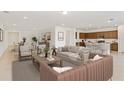 Sun-filled living room featuring stylish furniture and seamless flow into dining area and kitchen at 4471 Sw 84Th Street Rd, Ocala, FL 34476