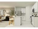 Modern kitchen with white cabinets, island, and stainless steel appliances at 1982 Sarah St, Winter Haven, FL 33884