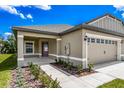 House exterior with tan siding, gray roof and walkway at 3179 Seville St, Lake Alfred, FL 33850