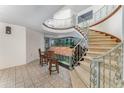 Stunning foyer with custom staircase, wrought iron railing, tile floors and a large aquarium at 6141 Palmetto Dr, Indian Lake Estates, FL 33855