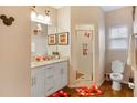 Bathroom with double vanity, shower, and Mickey Mouse decor at 3231 Cupid Pl Pl, Kissimmee, FL 34747