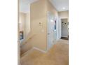 Upstairs hallway with carpet and doors to bedrooms at 3231 Cupid Pl Pl, Kissimmee, FL 34747