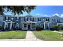 Attractive townhomes featuring neat landscaping, inviting entryways, and a well-maintained exterior at 525 Waterside Pointe Dr, Groveland, FL 34736
