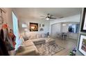 Cozy living room featuring a comfortable sectional sofa and neutral tones at 525 Waterside Pointe Dr, Groveland, FL 34736
