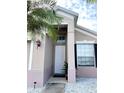 Front entrance with white door and landscaping at 14637 Huntcliff Park Way, Orlando, FL 32824