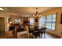 Charming dining area with a rustic wooden table and chandelier at 469 Blue Heron Cir # 469, River Ranch, FL 33867