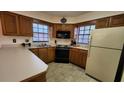 Cozy kitchen featuring wood cabinets and ample counter space at 469 Blue Heron Cir # 469, River Ranch, FL 33867