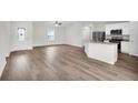 Open concept living area with kitchen and wood-look floors at 15605 Sw 49Th Ave Rd, Ocala, FL 34473