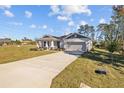 Exterior view of a house showing a concrete driveway and yard at 5830 Sw 121 St, Ocala, FL 34481