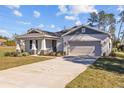 Front view of a house with a driveway and landscaping at 5830 Sw 121 St, Ocala, FL 34481