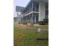 Low-rise apartment building featuring screened balconies, mature landscaping, and architectural facade at 1600 W Lake Parker Dr # A6, Lakeland, FL 33805