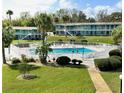 Community pool area with white picket fence, lounge chairs, and manicured lawn space at 1600 W Lake Parker Dr # A6, Lakeland, FL 33805
