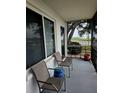Relaxing screened porch with chairs, side table, and tranquil views of the lake at 1600 W Lake Parker Dr # A6, Lakeland, FL 33805