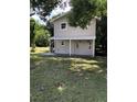 Two-story home featuring a covered porch and a well-maintained lawn with mature trees at 810 Avenue L Sw, Winter Haven, FL 33880