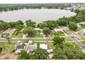 Aerial view showcases home's location near a lake and surrounding neighborhood at 415 Avenue K Ne, Winter Haven, FL 33881