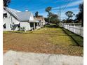 House with a large side yard and a white picket fence at 415 Avenue K Ne, Winter Haven, FL 33881