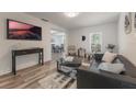 Spacious living room with a black leather couch and large TV at 521 W Voorhis Ave, Deland, FL 32720