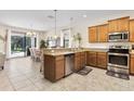 Spacious kitchen with stainless steel appliances and granite countertops at 1463 Myrtlewood St, Davenport, FL 33896