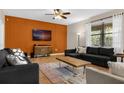 Living room with sectional sofa and an accent wall at 1463 Myrtlewood St, Davenport, FL 33896