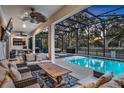 Screened pool and patio area with comfortable seating at 2541 Shanti Dr, Kissimmee, FL 34746