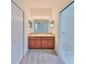 Double vanity bathroom with a large mirror and neutral color scheme at 3379 Fiddle Leaf Way, Lakeland, FL 33811