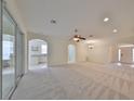 Bright and airy living room with neutral carpeting and an open design at 3379 Fiddle Leaf Way, Lakeland, FL 33811